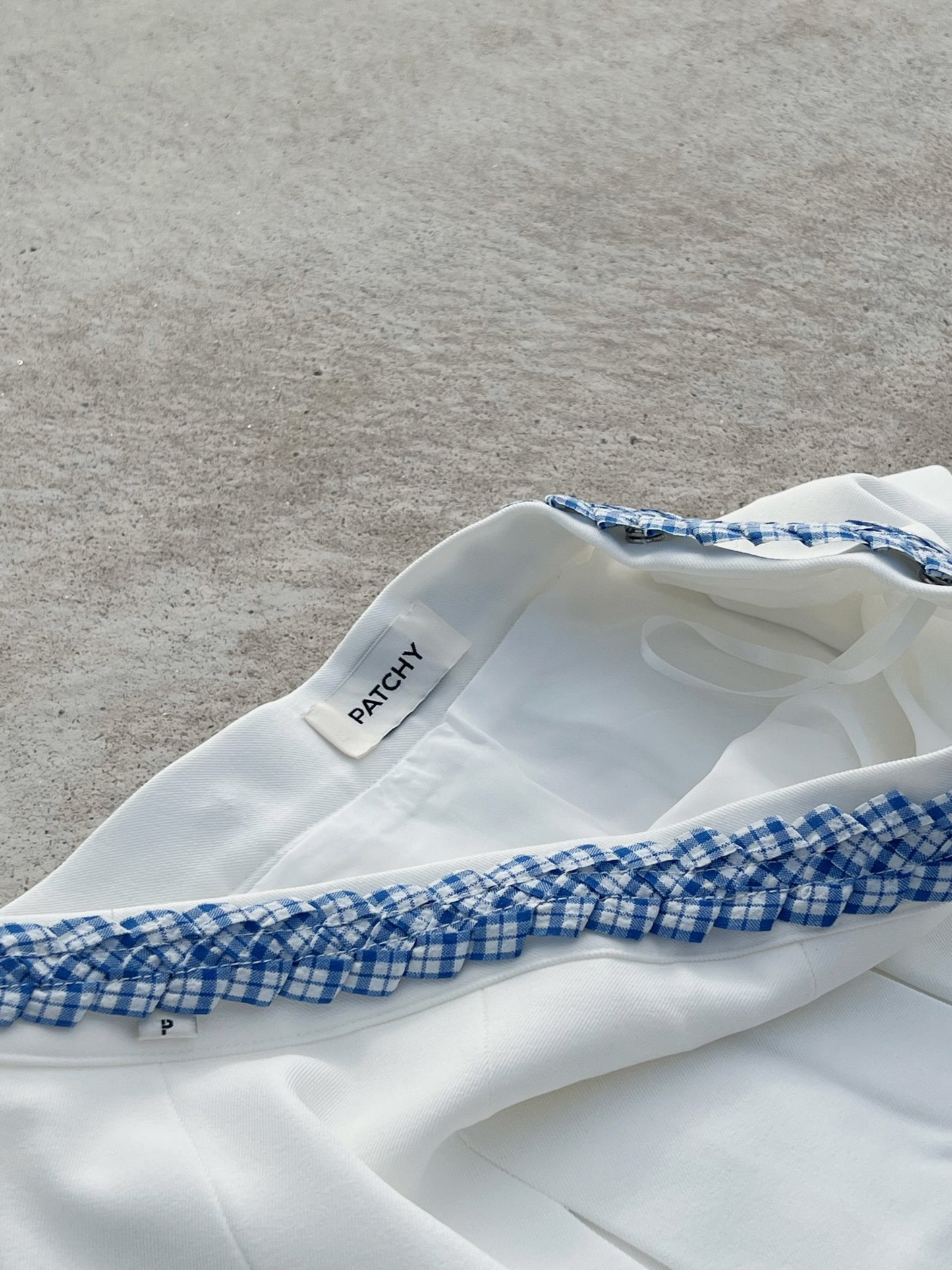 Patchy - White Pleated Mini Skirt with Blue and White Plaid Twisted Strap